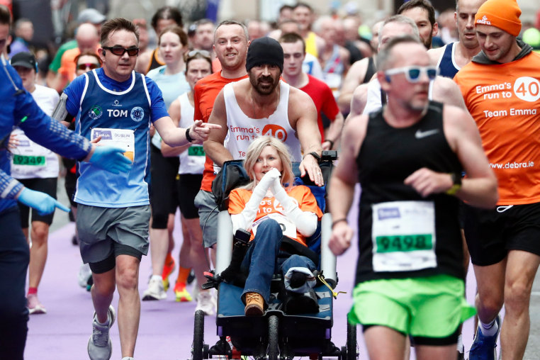 Actor Colin Farrell pushes close friend Emma Fogarty as he runs