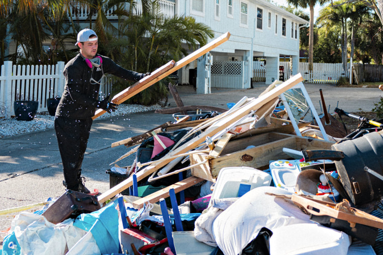 A construction worker removes a bathroom that was damaged in Hurricane Helene in Indian Rocks Beach, Fla., on Oct. 18, 2024.