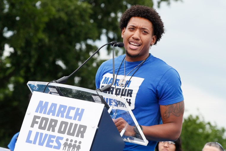 Trevon Bosley speaks onstage behind a podium with a sign that says "March for Our Lives"