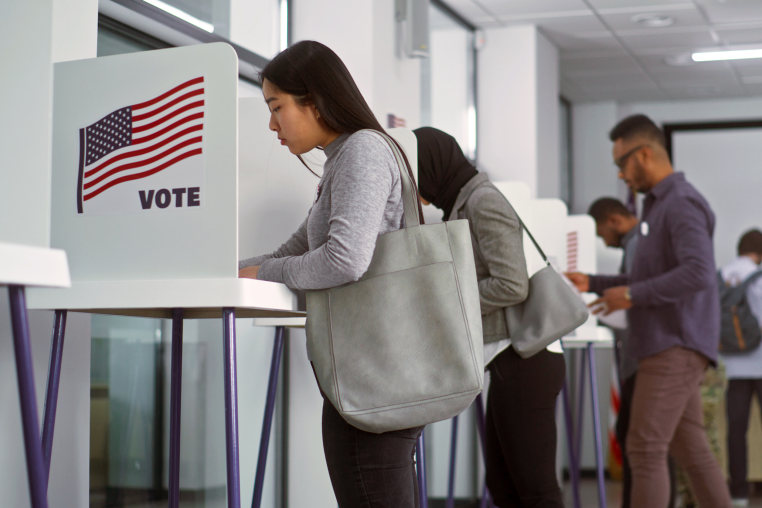 Asian woman voting booths in polling station office