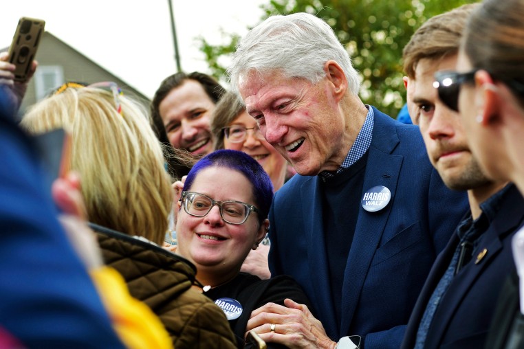 Former President Bill Clinton poses for a photograph with Carol Churchey, of Johnstown, while a campaigning for Democratic Party presidential nominee Vice President Kamala Harris during a stop at Bottle Works in the Cambria City section of Johnstown, Pa., on  Oct. 29, 2024. 