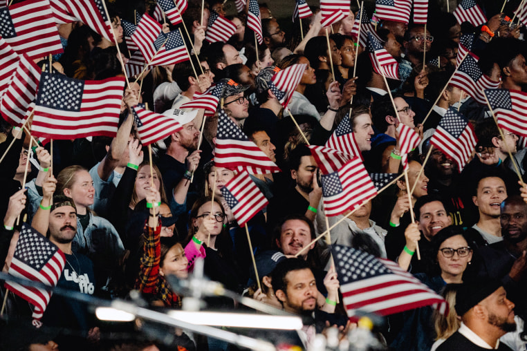 Supporters wave American flags