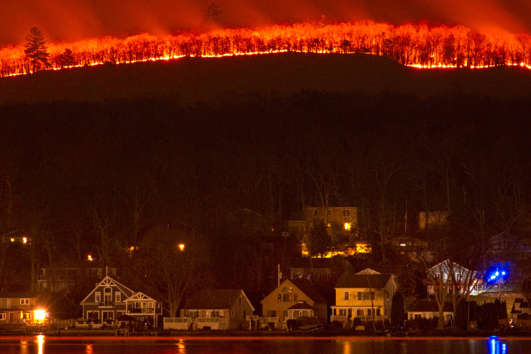 The Jennings Creek wildfire burning behind homes