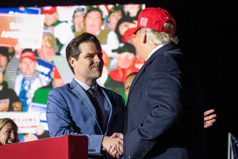 Matt Gaetz shakes hands with Donald Trump.