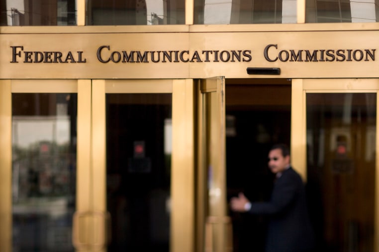 A man walks into the Federal Communications Commission (FCC) headquarters