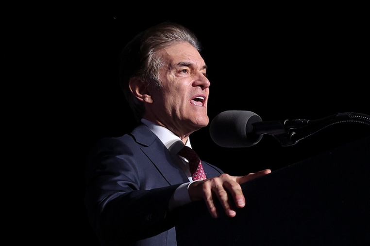 Dr. Mehmet Oz speaks as Donald Trump listens at a rally