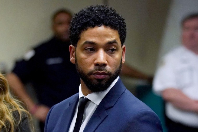 Jussie Smollett stands in a courtroom