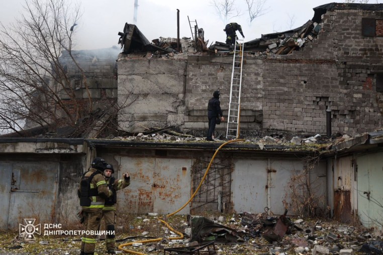 Firefighters work at the site of a Russian missile strike