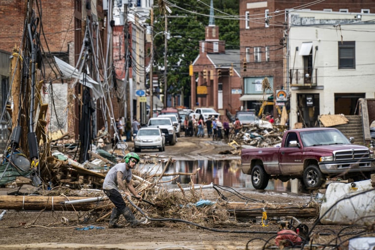 Workers, community members, and business owners clean up debris in the aftermath of Hurricane Helene.