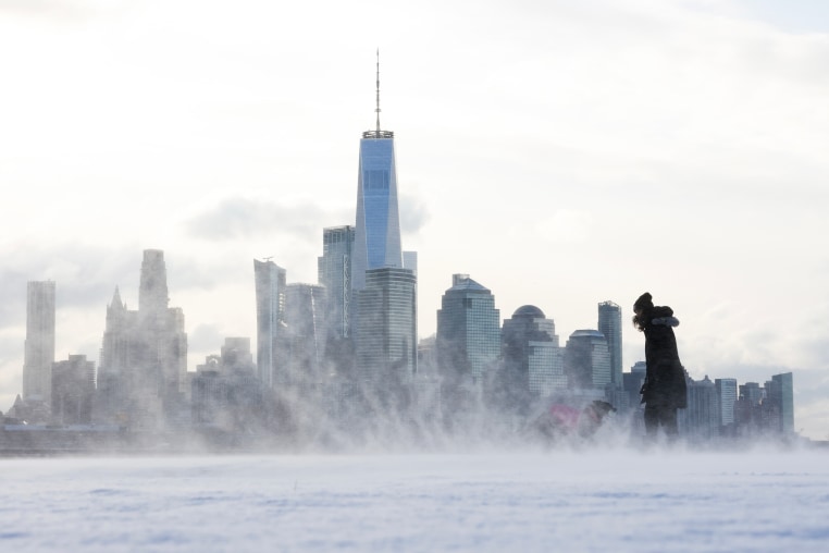 A person plays with a dog in Hoboken, New Jersey on Dec. 21, 2024. 