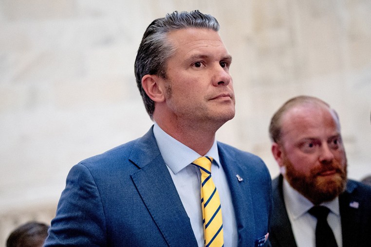 Pete Hegseth and his wife, Jennifer Rauchet, walk through the Russell Senate Office building on Capitol Hill on Dec. 3, 2024.