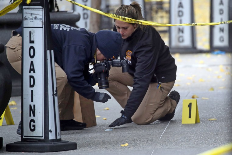 Police place bullet casing markers outside of a Hilton Hotel in Midtown Manhattan where United Healthcare CEO Brian Thompson was fatally shot on Dec. 4, 2024.