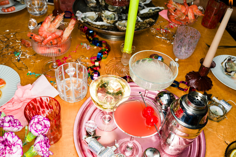 Cocktails, champagne and a shaker on a table with decorations  for a NYE party