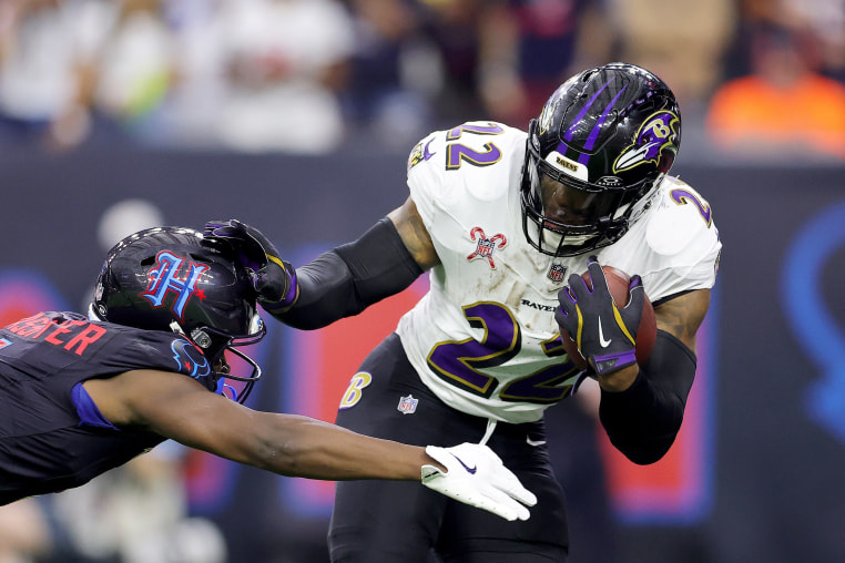 Kamari Lassiter #4 of the Houston Texans tackles Derrick Henry #22 of the Baltimore Ravens for a safety during the second quarter  on Dec. 25, 2024 in Houston.