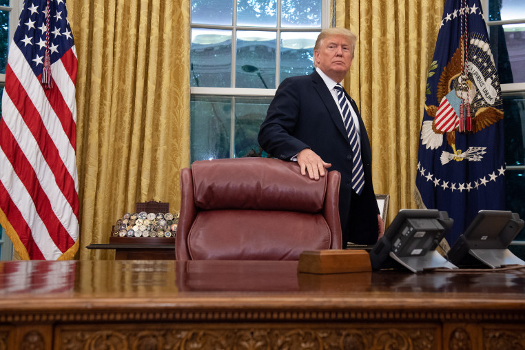 Then President Donald Trump stands behind the Resolute Desk in 2018.