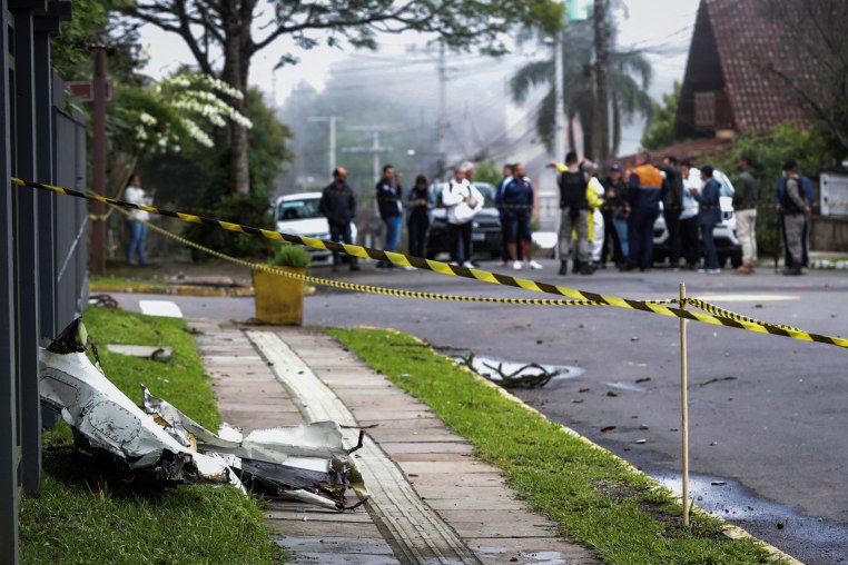 A piece of plane debris on a sidewalk sectioned off with caution tape