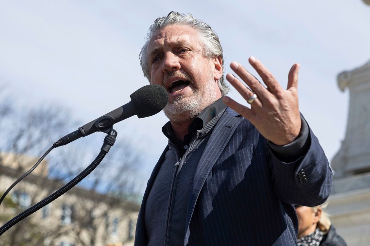 Anti-vaccine activist Del Bigtree speaks at a rally outside the Supreme Court 