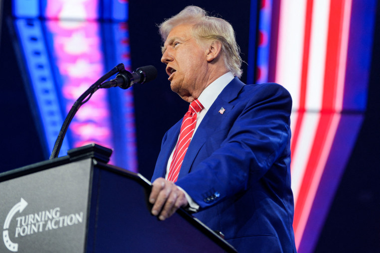 Donald Trump speaks at a podium