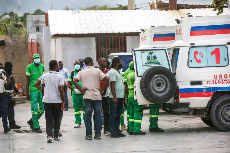 Medics inspect an ambulance of wounded people, shot by armed gangs at the General Hospital