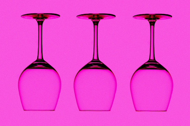 three empty, upside down wine glasses