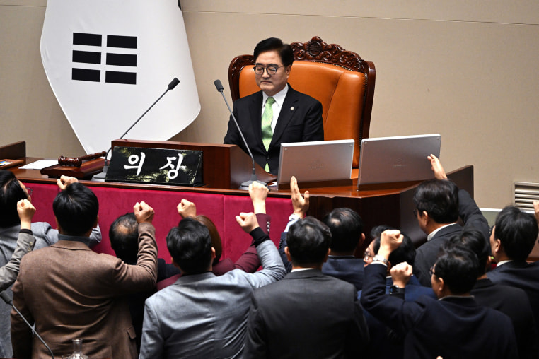 South Korea's ruling People Power Party lawmakers argue with National Assembly Speaker Woo Won-shik over the impeachment of acting president Han Duck-soo at the National Assembly in Seoul on December 27, 2024. 