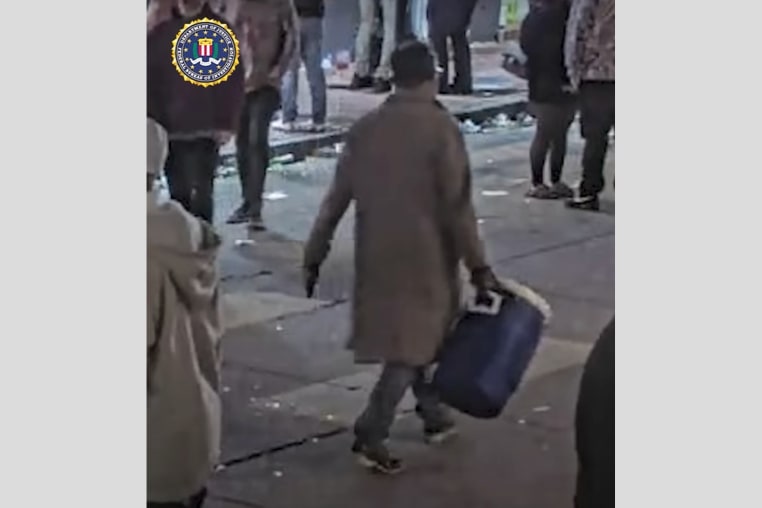 Shamsud Din Jabbar carries a cooler outside on the street