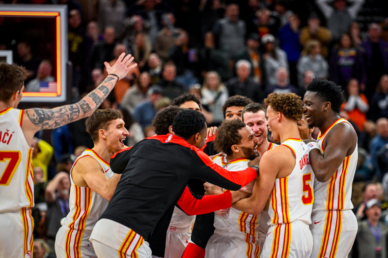 Trae Young celebrates with team.