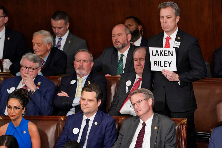 Rep. Andy Ogles, R-Tenn., holds a sign with the name of slain Georgia student Laken Riley as President Joe Biden delivers his State of the Union address 