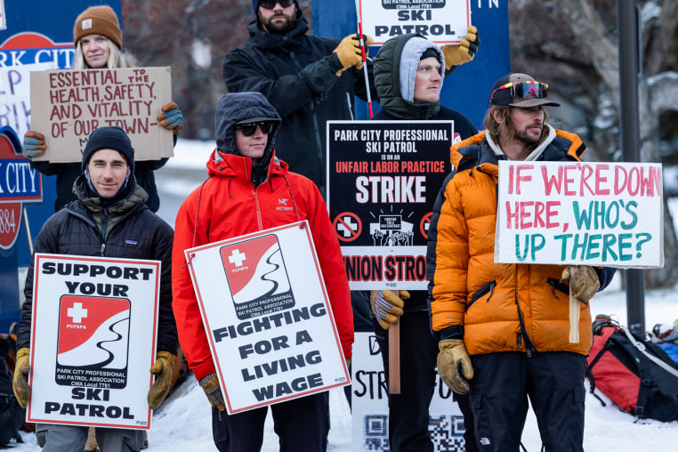 Park City Ski Patrol strikers hold signs