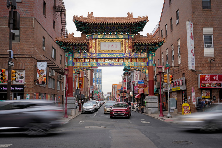 Evening traffic passes near the Chinatown neighborhood of Philadelphia.