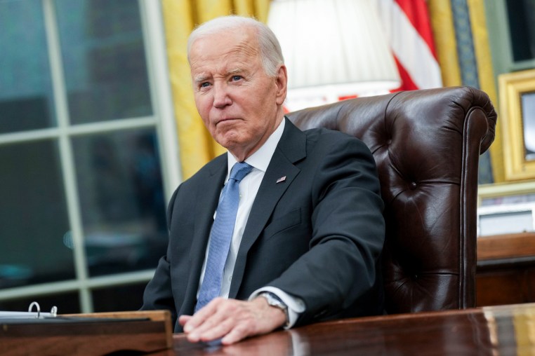 Joe Biden sits at his desk in the oval office