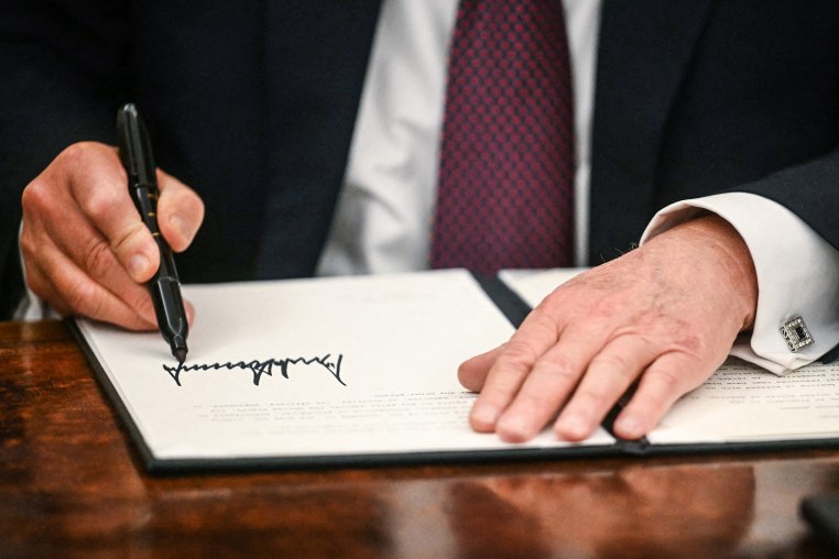 Image: President Donald Trump signs executive orders in the Oval Office