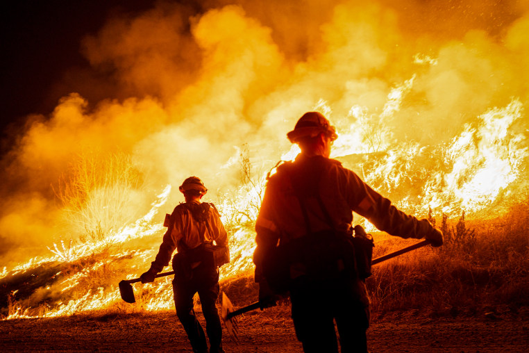 Firefighters in the middle of a wildfire.