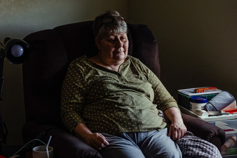 Kaye Peterson sits in her room at Village of Lebanon assisted living facility