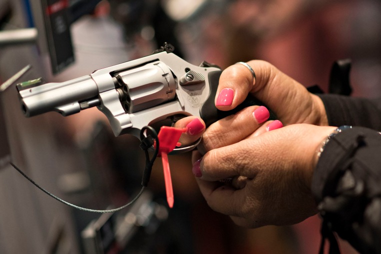 An attendee handles a Smith & Wesson pistol