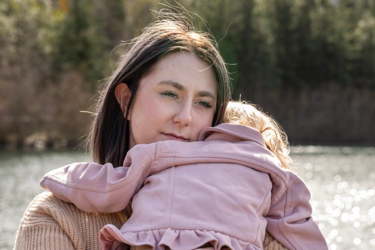 Saige Dahmen holds her daughter at a park in Beaverton, Oregon. 