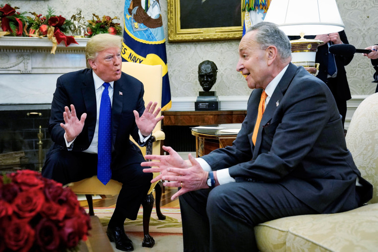 Donald Trump speaks to Chuck Schumer, both seated inside of the Oval Office