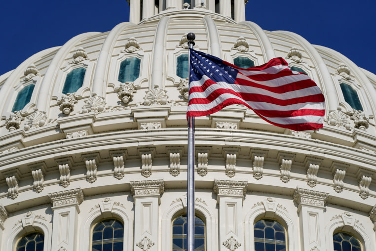 Capitol dome with the U.S. flag.