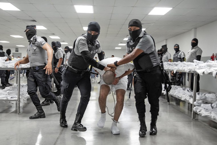 A shackled alleged member of the Venezuelan criminal organization Tren de Aragua deported from the U.S. upon arrival in Tecoluca, El Salvador.