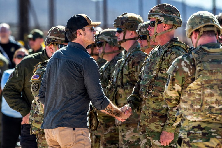 Defense Secretary Pete Hegseth shakes hands with an Army soldier 