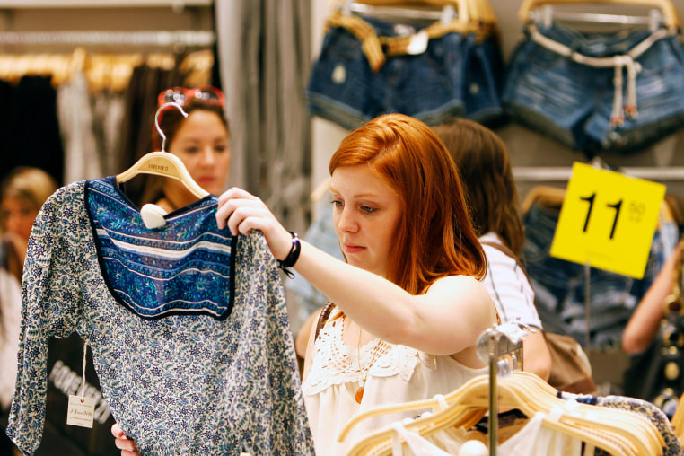 A customer looks at a top inside a Forever 21 store.