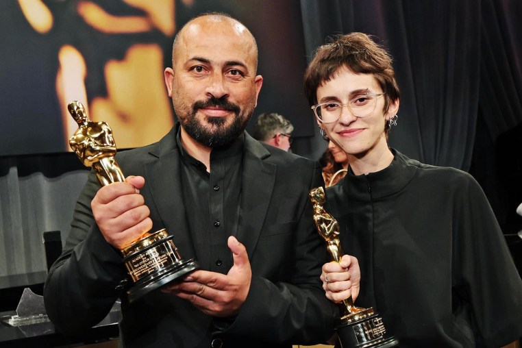 Hamdan Ballal and Rachel Szor hold their Oscars for "No Other Land" on March 2, 2025 in Hollywood.