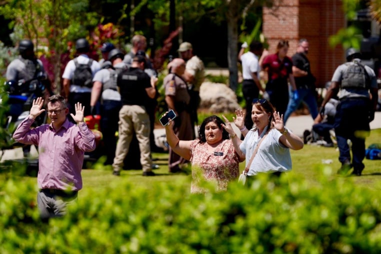 Evacuees come out with their hands up