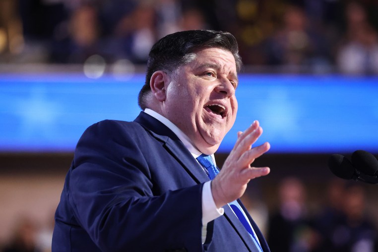 JB Pritzker speaks on stage at the DNC