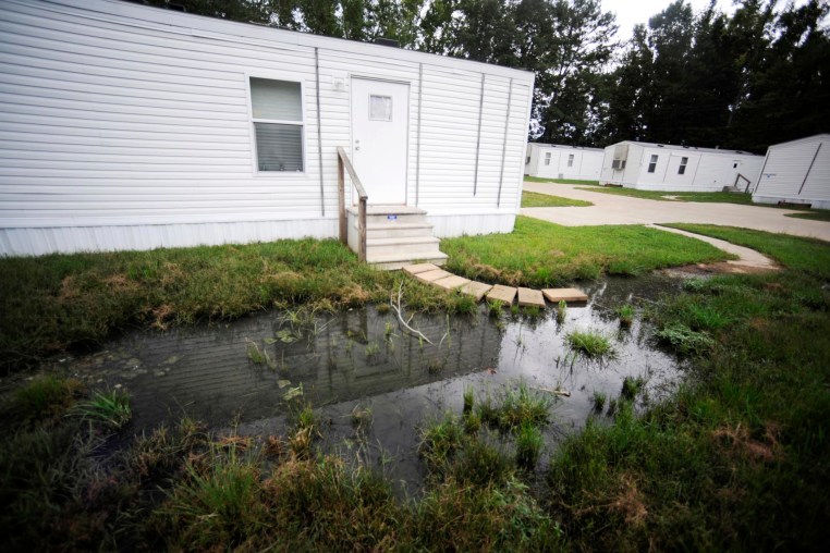 Fetid water pools outside a mobile home in Lowndes County, Ala.