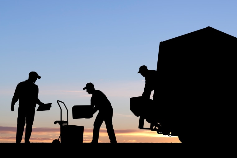 Moving Day workers unload a truck silhouette