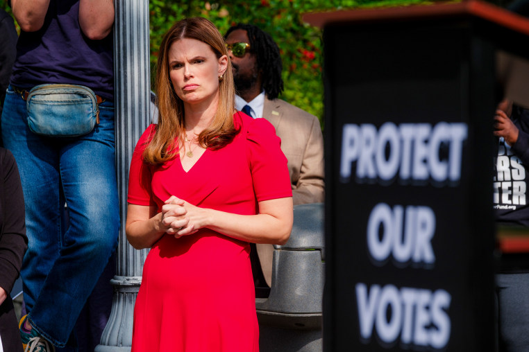 Allison Riggs at a protest against her opponent's efforts to toss out scores of ballots 