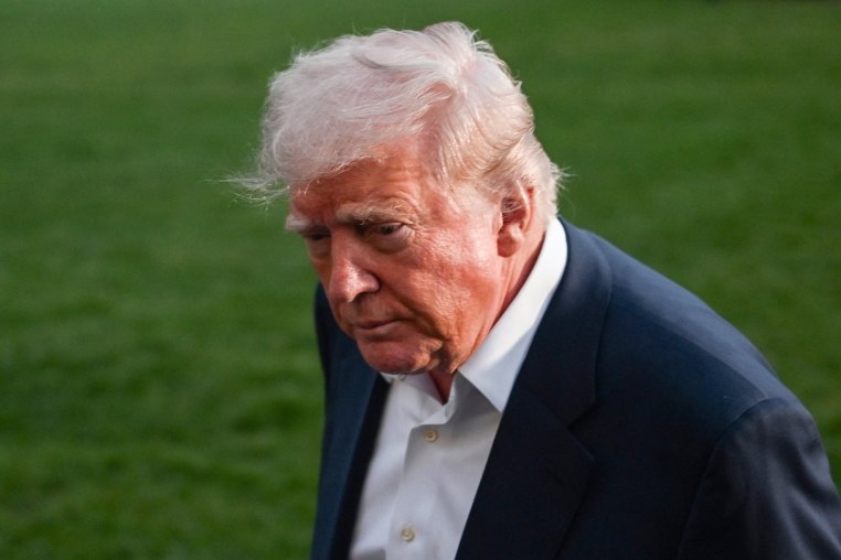 President Donald Trump leaves after taking questions from reporters