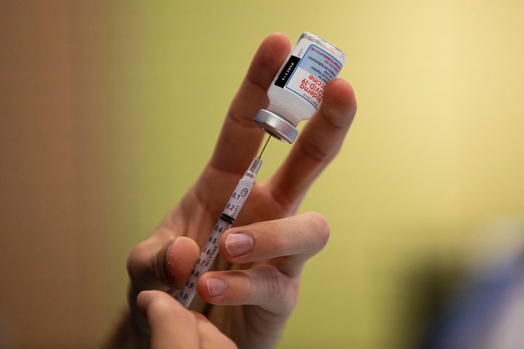 A dose of a Moderna COVID-19 vaccine is prepared in 2021.