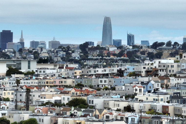 An aerial view of homes in front of the San Francisco skyline